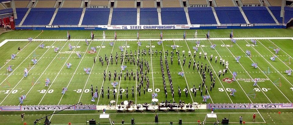 Marching band performing on a football field during a show.
