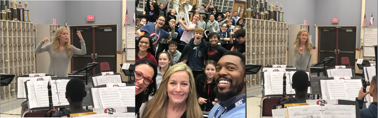 A large group of diverse people smiling and posing for a selfie outdoors.